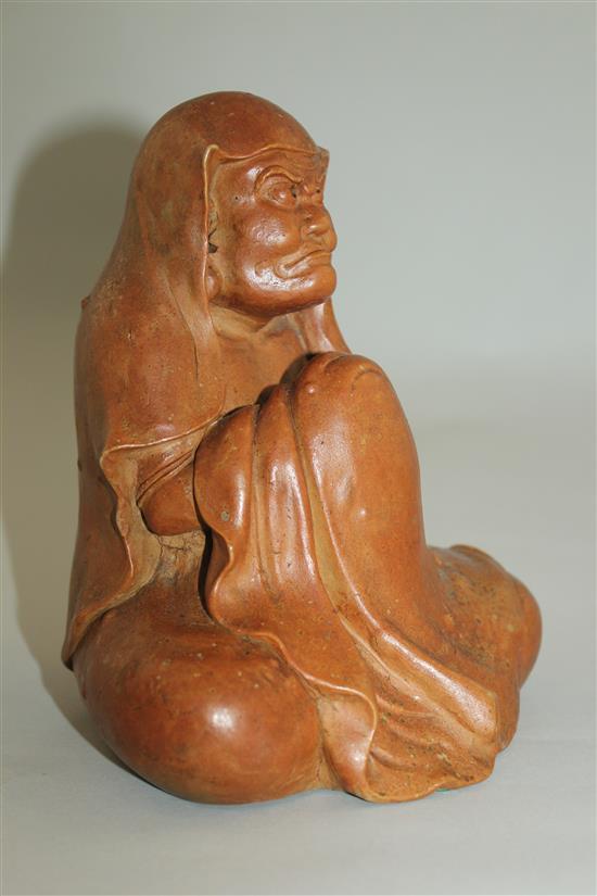 A Japanese stoneware seated figure of Daruma, 19th century, 18.5cm